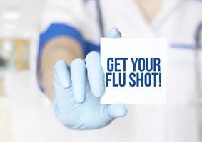få din influensa shot text på kortet i händerna på läkare närbild foto