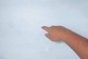 handgest av en asiatisk man som pekar ner, ovanifrån, knapptryckningskoncept, isolerad på vit bakgrund. foto