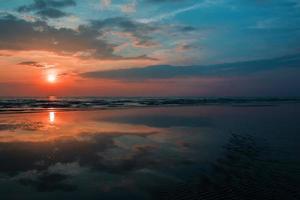 malign soluppgång till solnedgång röd himmel till havs. foto