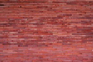 orange tegelvägg textur bakgrund. vintage mönster tapeter. tom tegelvägg. orange nyans brickwall bakgrund. hemväggsinredning. orange vägg av huset. ljus orange färg tegel. foto