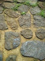 strukturdetaljer på väggarna av stenmaterial, bra för naturlig bakgrund foto