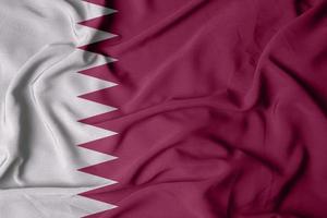 selektiv inriktning av Qatar flagga, med viftande tyg textur i vinröd färg foto