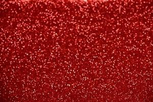 rött glitter bokeh ljus suddig abstrakt bakgrund för alla hjärtans dag, födelsedag, årsdag, bröllop, nyår och jul foto