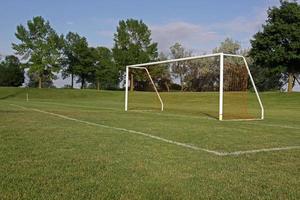 ett tomt fotbollsmål på ett spelplan foto
