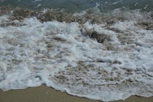 strandvågor och sand foto