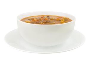 skål med grönsaksnöt soppa på en vit bakgrund