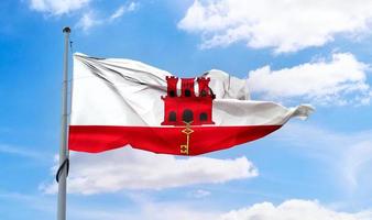 gibraltarflagga - realistiskt viftande tygflagga. foto