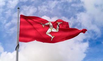 isle of man flagga - realistiska viftande tygflagga foto