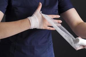 medicinsk vitt bandage i händerna på en kvinnlig läkare foto