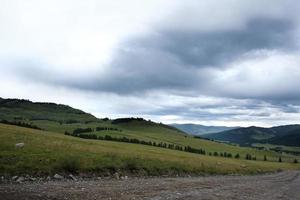 band av vägen bland sluttningarna av bergen på vidderna av altai en sommardag foto