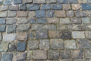 granit sten trottoar textur. abstrakt bakgrund av gamla kullersten trottoaren närbild. foto