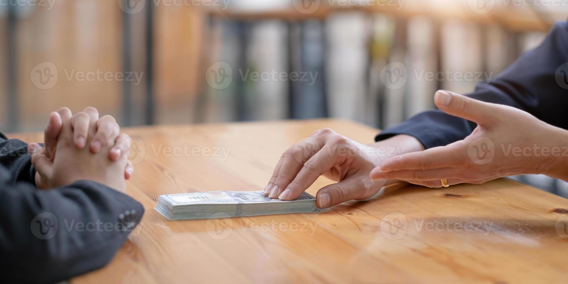 Aziatische zakenman die eigenaar is van het bedrijfsbord en persoonlijk de deal verzegelt met het ontvangen van smeergeld. Het concept van corruptie en anti-omkoping foto