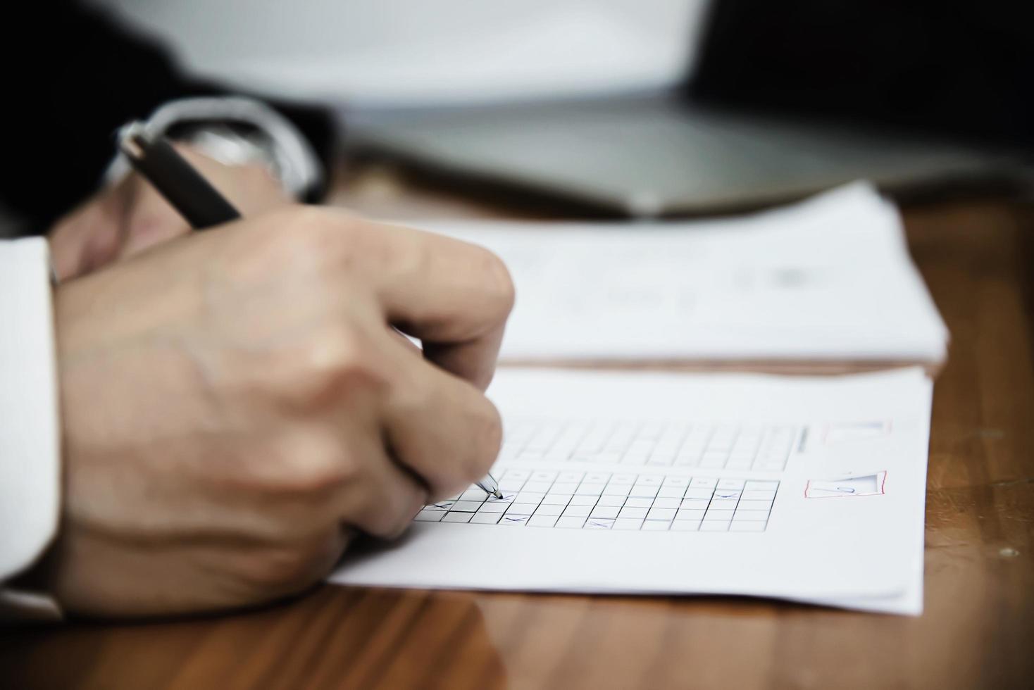 Instructeur die het examen van het meerkeuzenantwoordblad controleert - onderwijsmensen die met document testconcept werken foto