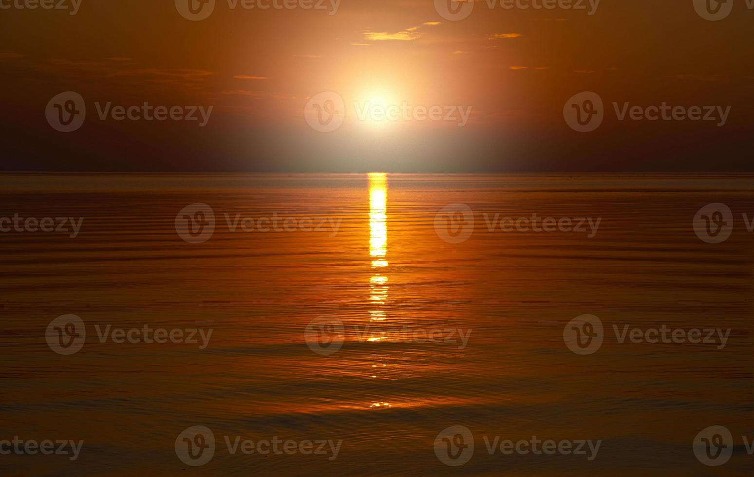 mooie oranje zonsondergang wordt weerspiegeld in de zee. foto