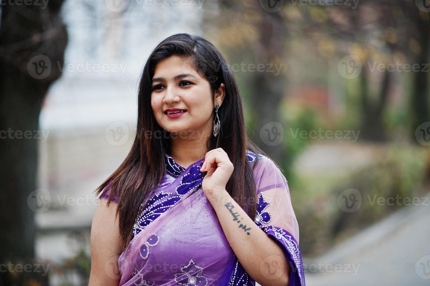 close-up portret van Indiase hindoe meisje op traditionele violet saree gesteld op straat. foto