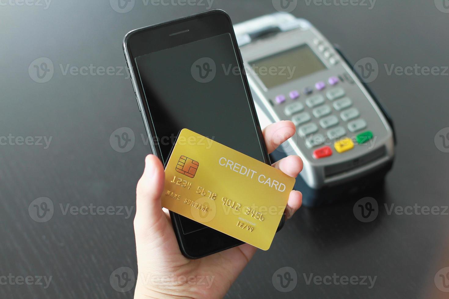 een vrouw die creditcard op smartphone gebruikt om producten in de winkel te kopen. concept van uitgaven via creditcard online winkelen. foto