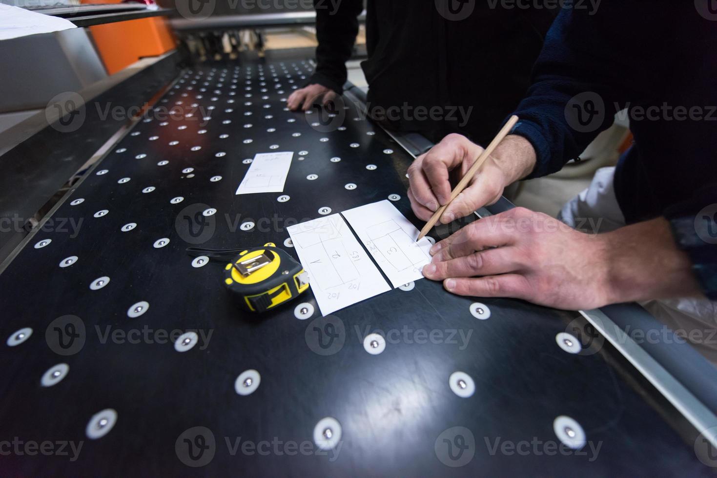 timmerlieden die een cnc-houtbewerkingsmachine berekenen en programmeren foto