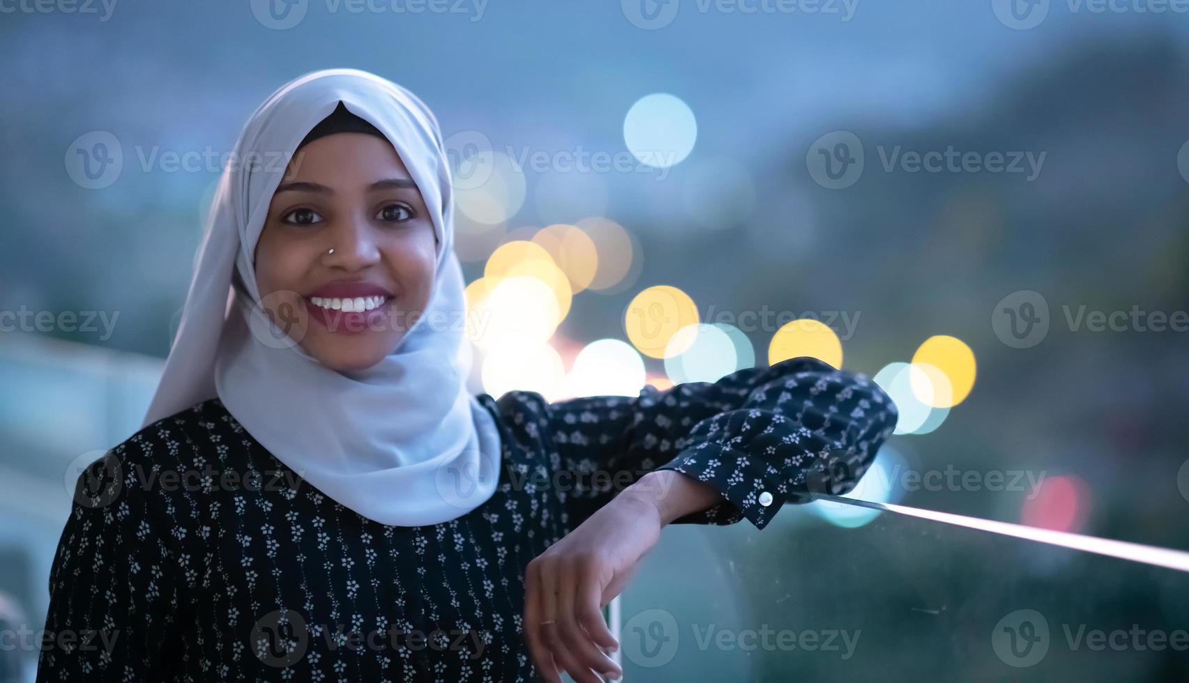 Afrikaanse moderne moslimvrouw in de nacht op het balkon foto