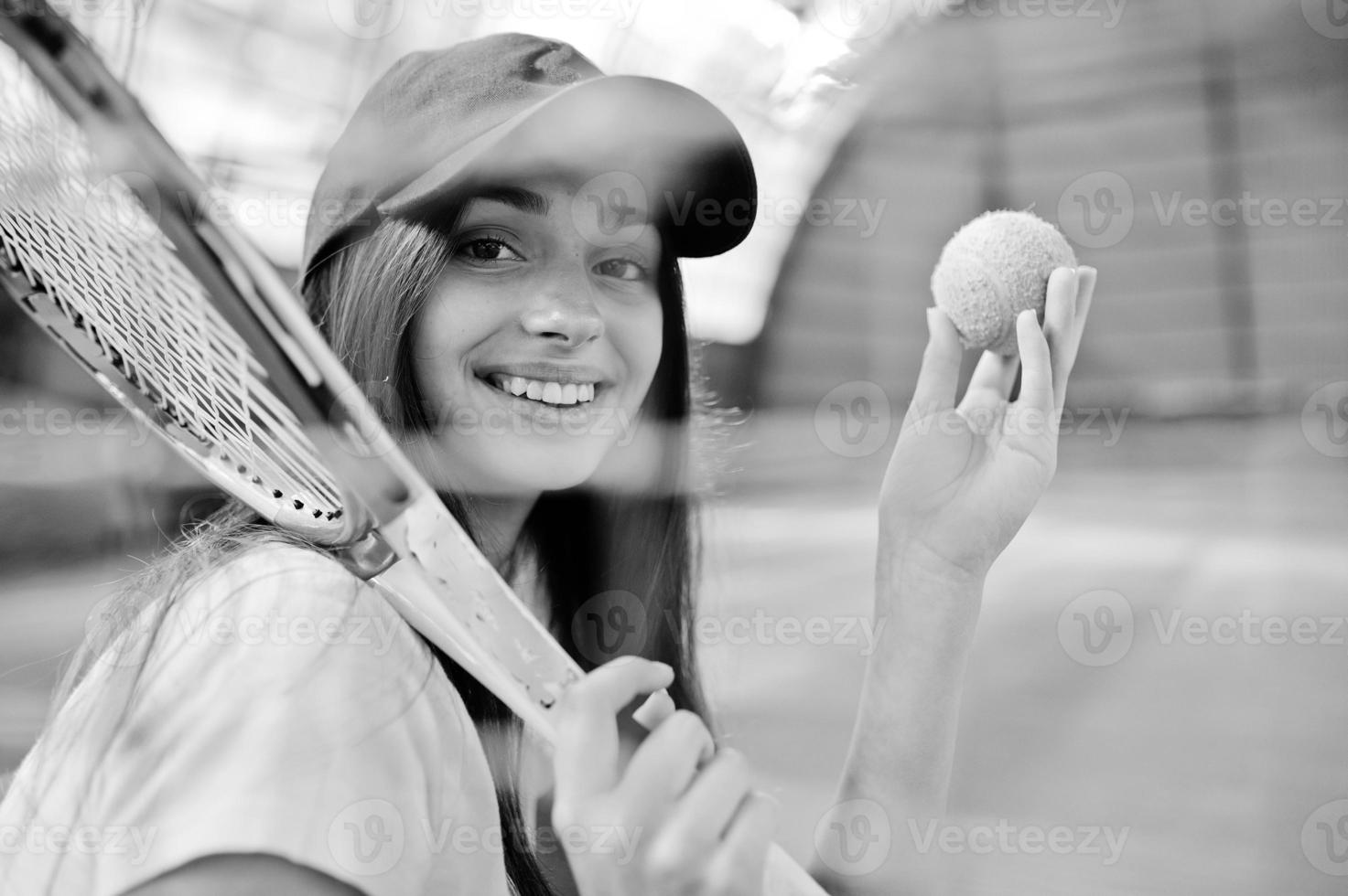 jonge sportieve meisjesspeler met tennisracket op tennisbaan. foto