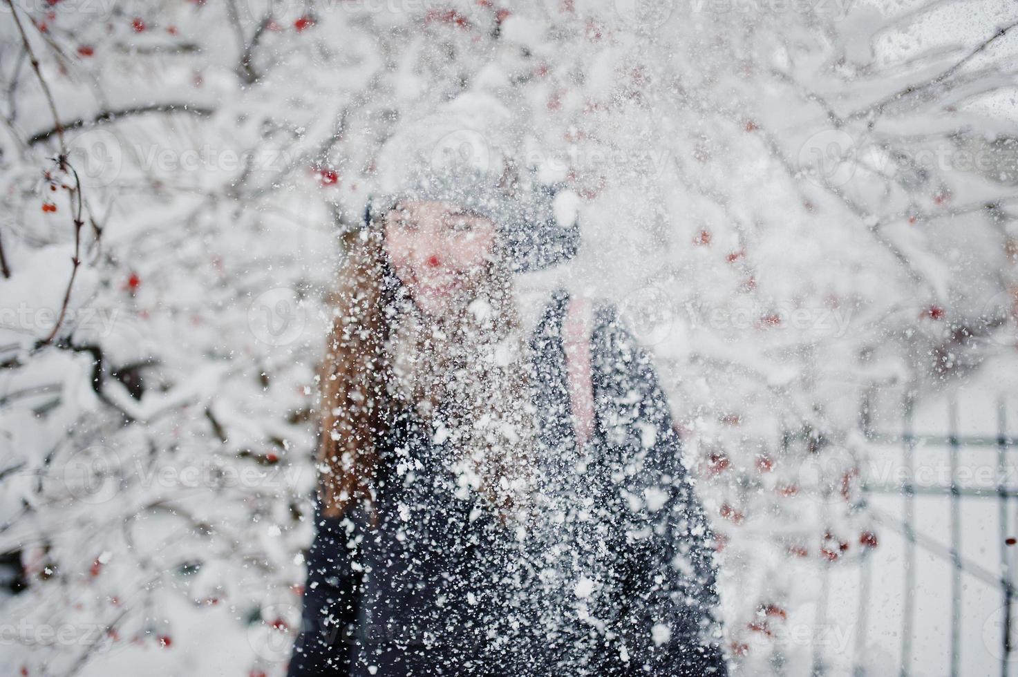 portret van meisje op besneeuwde winterdag in de buurt van besneeuwde bomen. foto