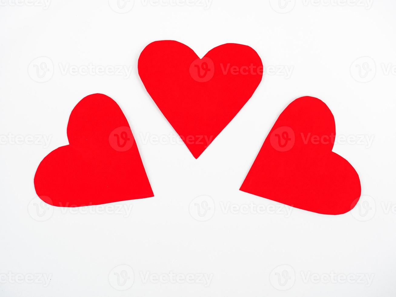 drie rode papieren harten op een witte achtergrond foto