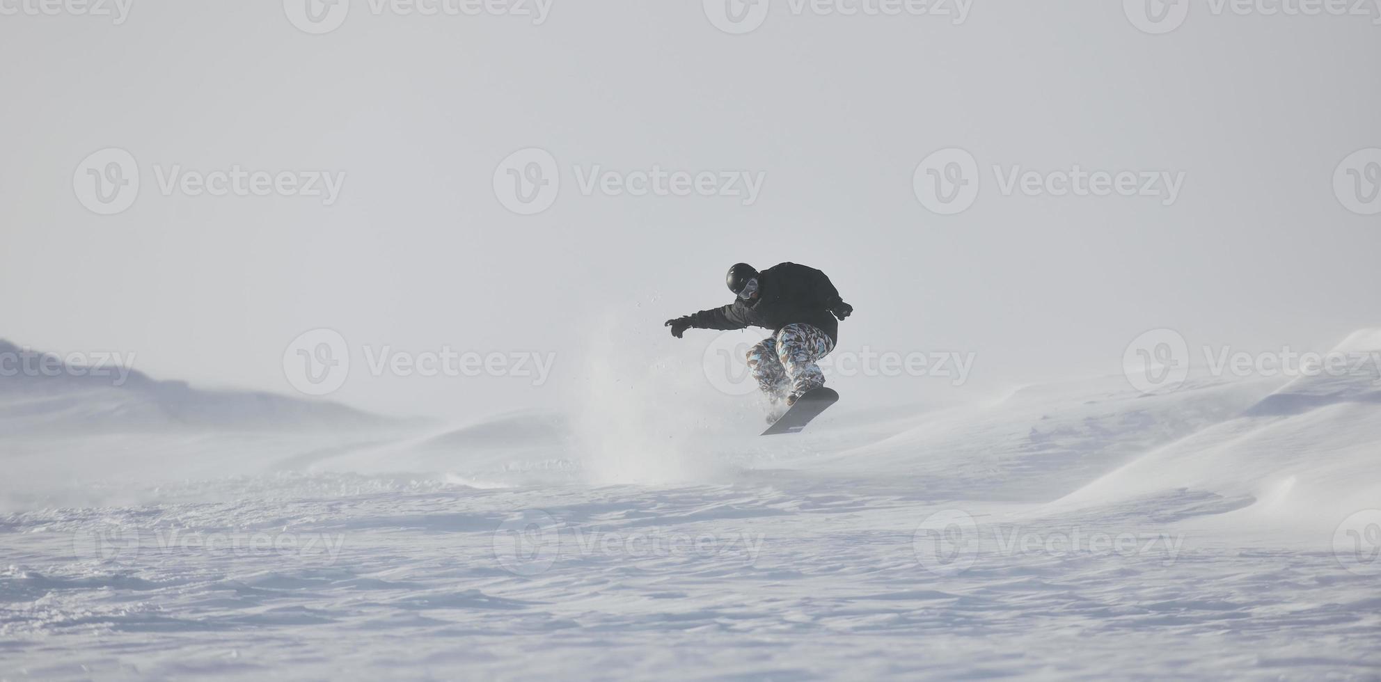 freestyle snowboarder springen en rijden foto