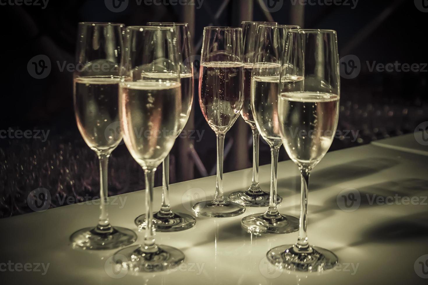 een groep van hoog elegant Champagne bril Aan een tafel foto