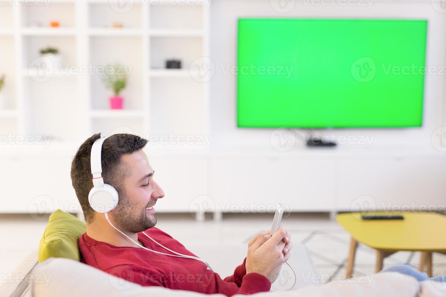 Mens genieten van muziek- door hoofdtelefoons foto