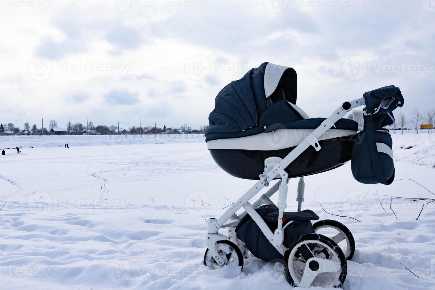 de kind slaapt in een wandelwagen in de winter. de concept van winter wandelingen met kinderen in de vers lucht. foto