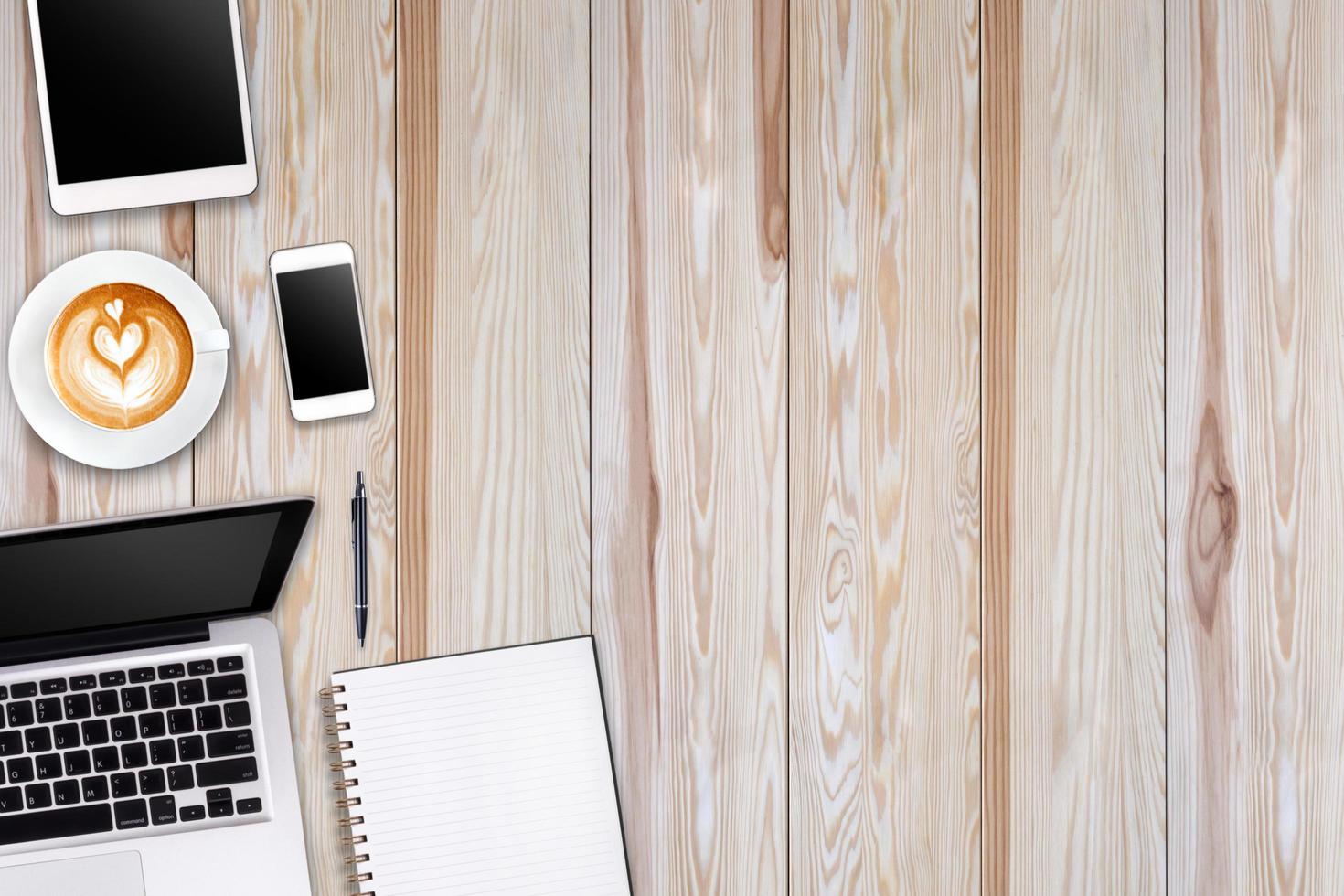 moderne werkruimte met laptop tablet, smartphone en koffiekopje kopieerruimte op hout achtergrond. bovenaanzicht. platte lay-stijl. foto