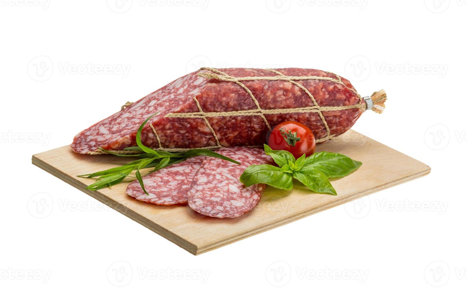 salami Aan houten bord en wit achtergrond foto