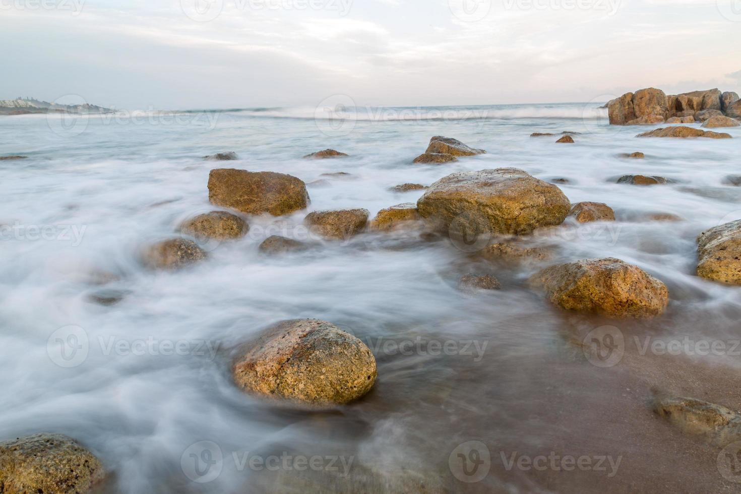 zeegezicht met rotsen in de voorgrond foto