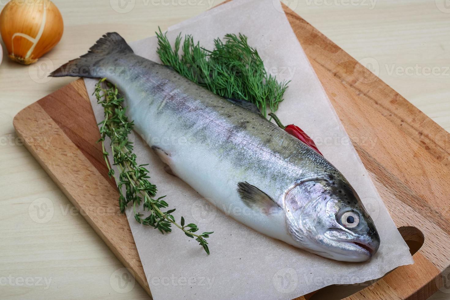 rauw forel Aan houten bord en houten achtergrond foto