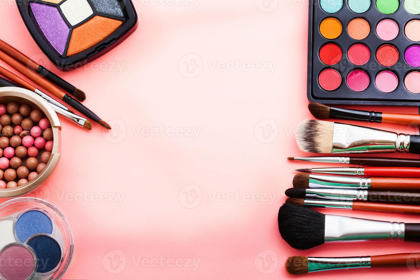 frame van cosmetische accessoires op roze achtergrond met kopie ruimte. bovenaanzicht foto