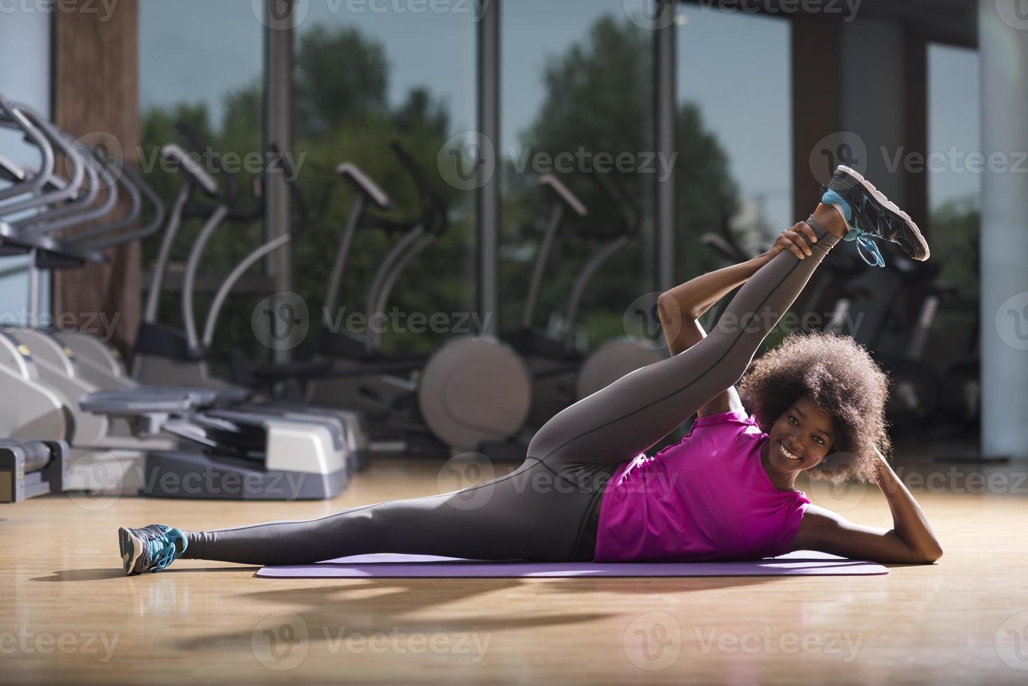 Afrikaanse Amerikaans vrouw oefening yoga in Sportschool foto