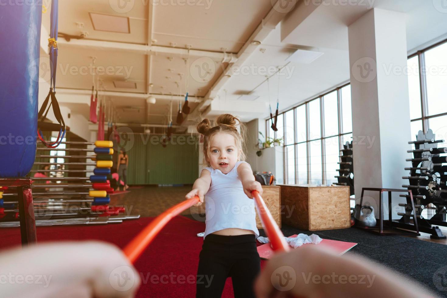 weinig meisje en mam aan het doen opdrachten met stokjes foto