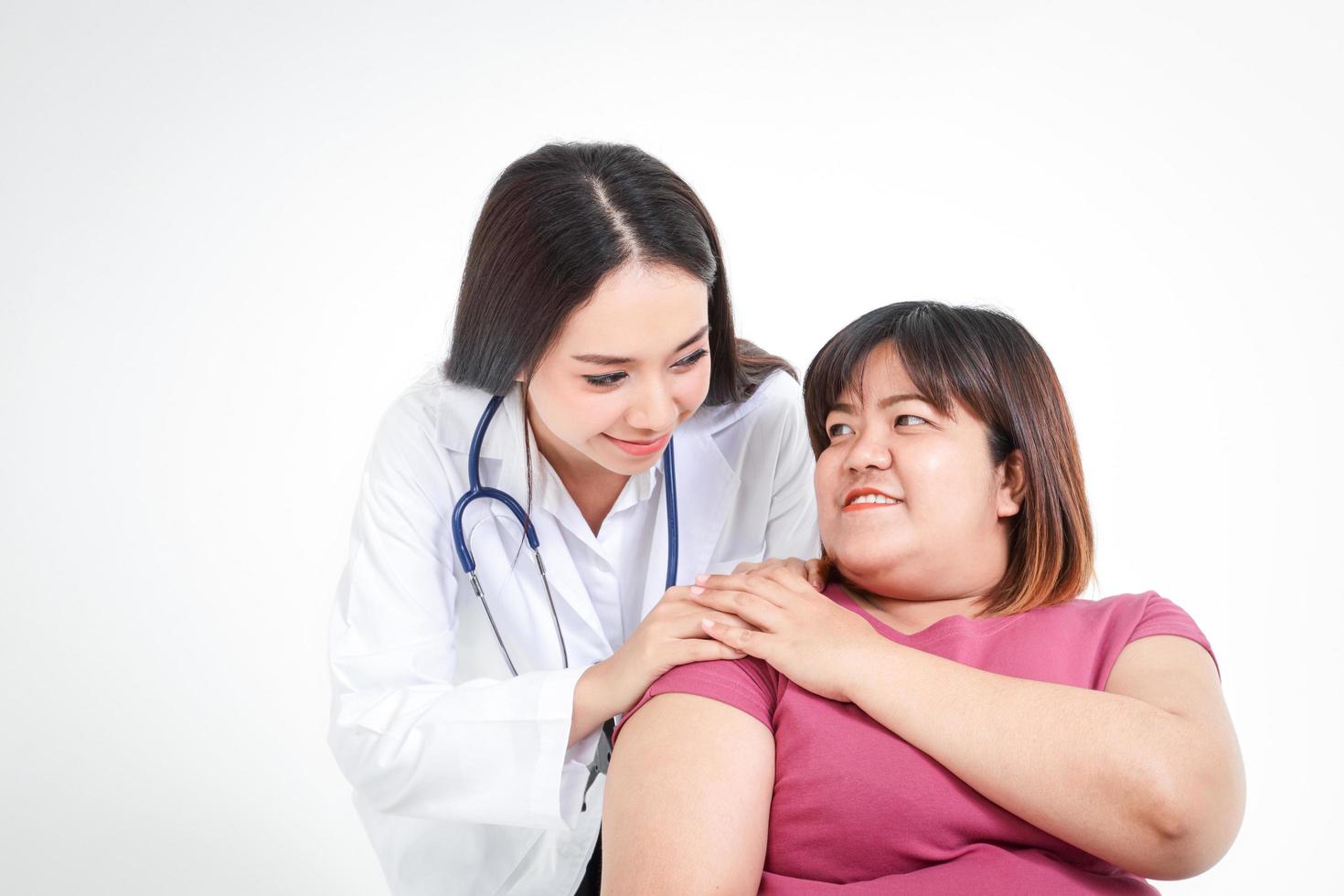 mooi vrouw dokter genezen aandoeningen van zwaarlijvig Dames patiënten Aziaten gezeten Aan een rolstoel. zwaarlijvigheid is een Gezondheid probleem voor de lichaam. concept van verliezende gewicht. kopiëren ruimte. wit achtergrond foto