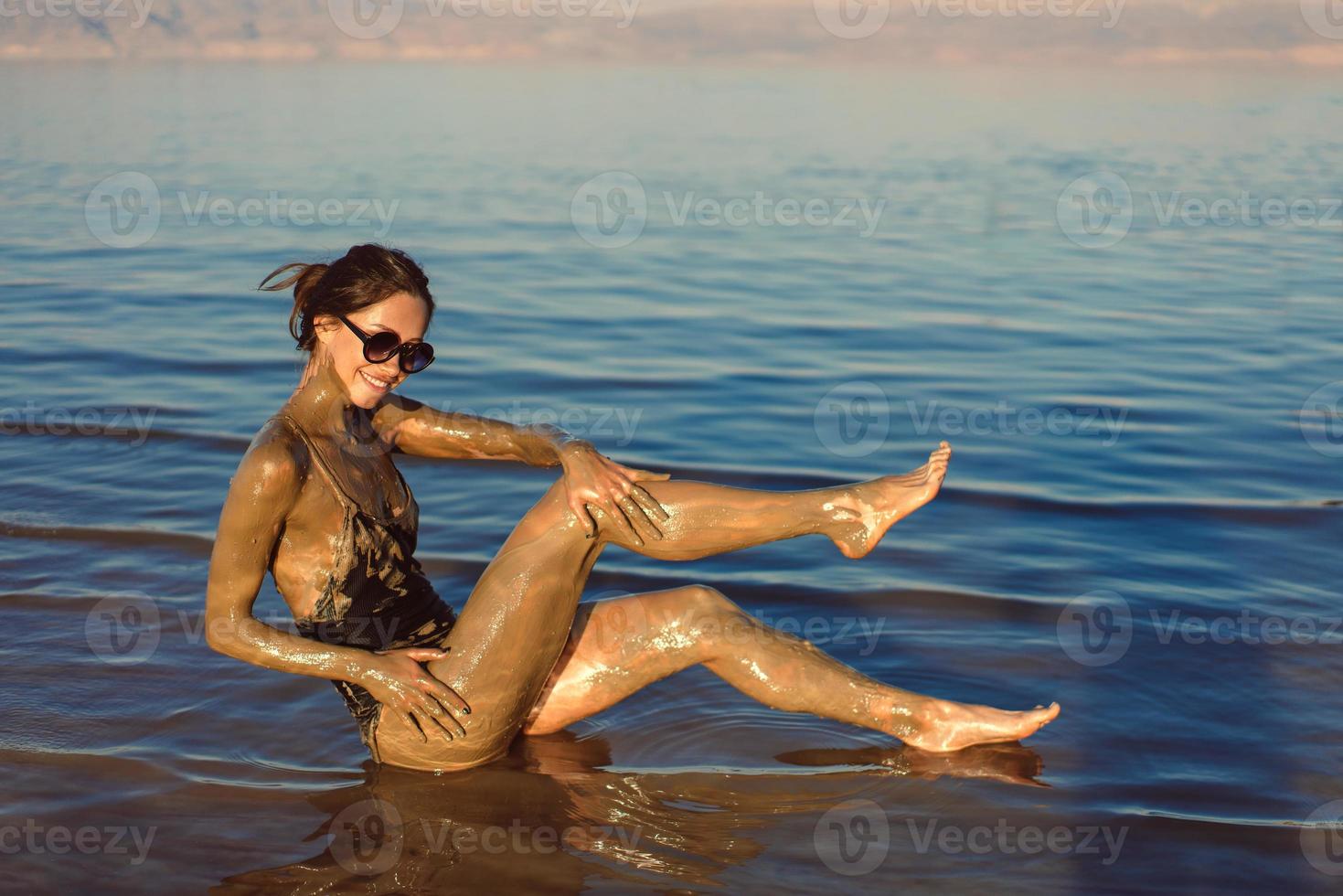 een jong vrouw genieten van de natuurlijk mineraal modder foto