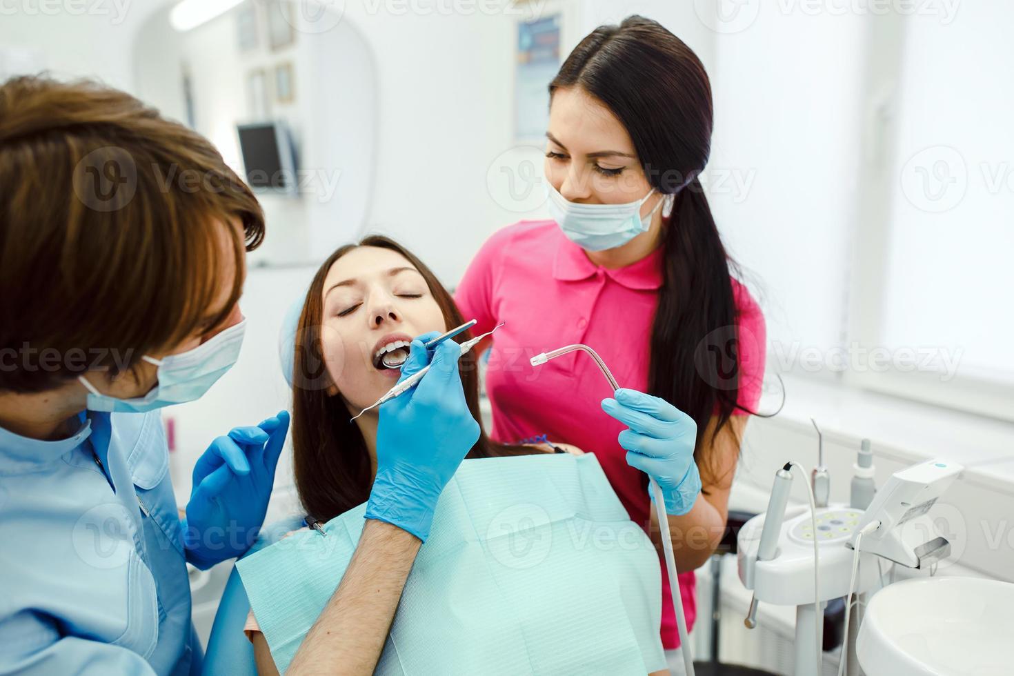 inspectie van de tanden van de meisje met de helpen van een spiegel foto