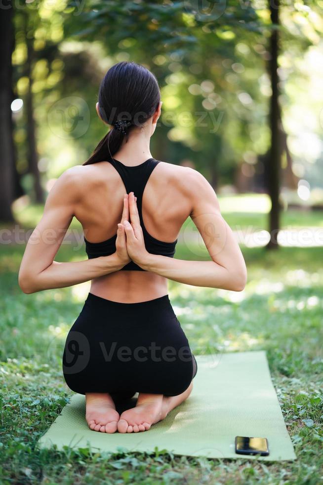 atletisch jong vrouw aan het doen yoga in de park in de ochtend. foto