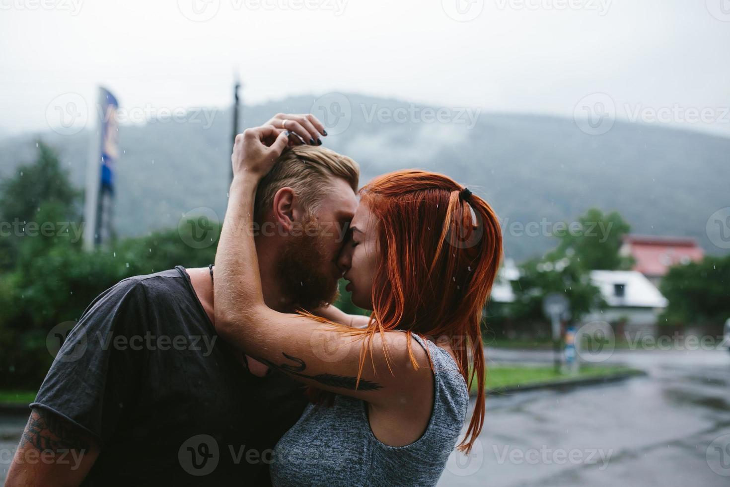 mooi paar knuffelen in de regen foto