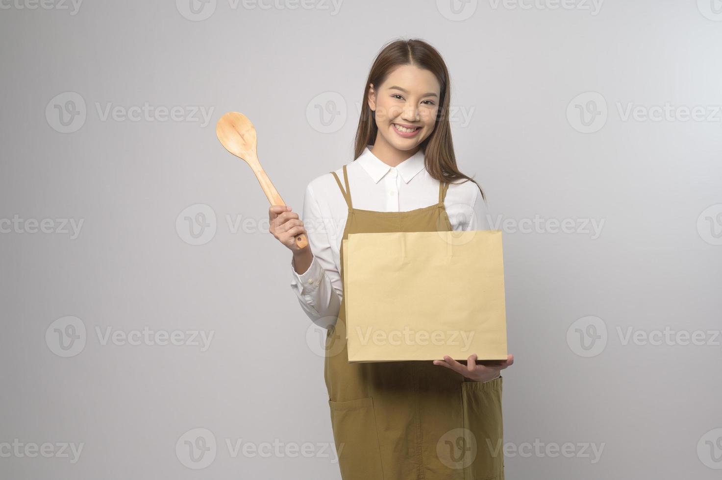 portret van jong Aziatisch vrouw vervelend schort over- wit achtergrond studio, Koken en ondernemer concept foto