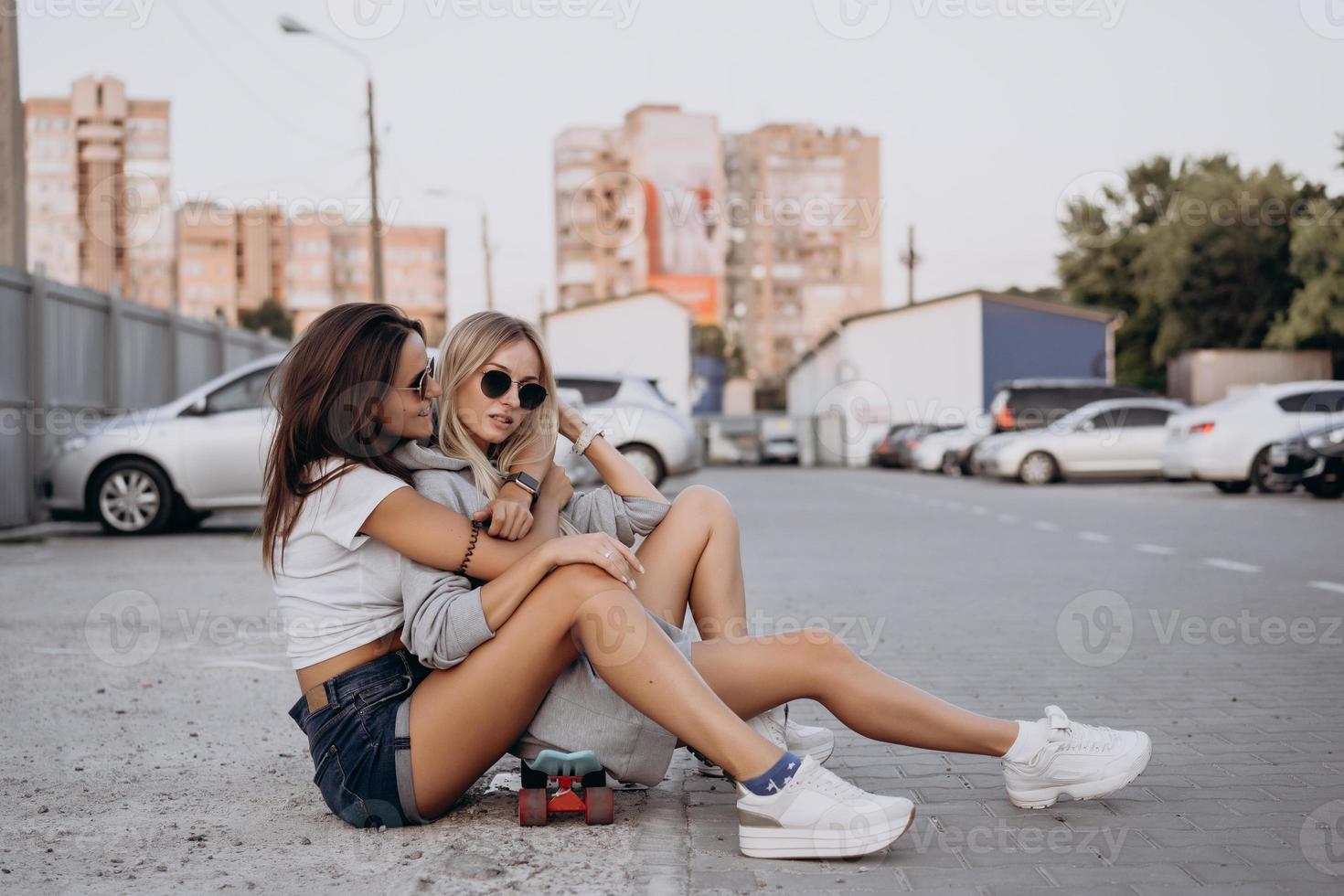 twee jong, sexy meisjes zijn zittend Aan de grond foto