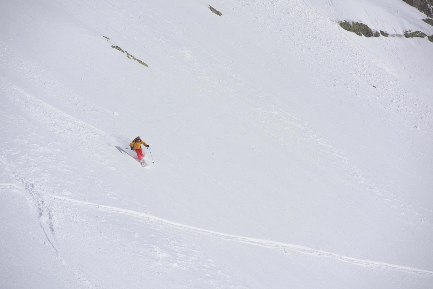 freeride skiër skiën in diepe poedersneeuw foto