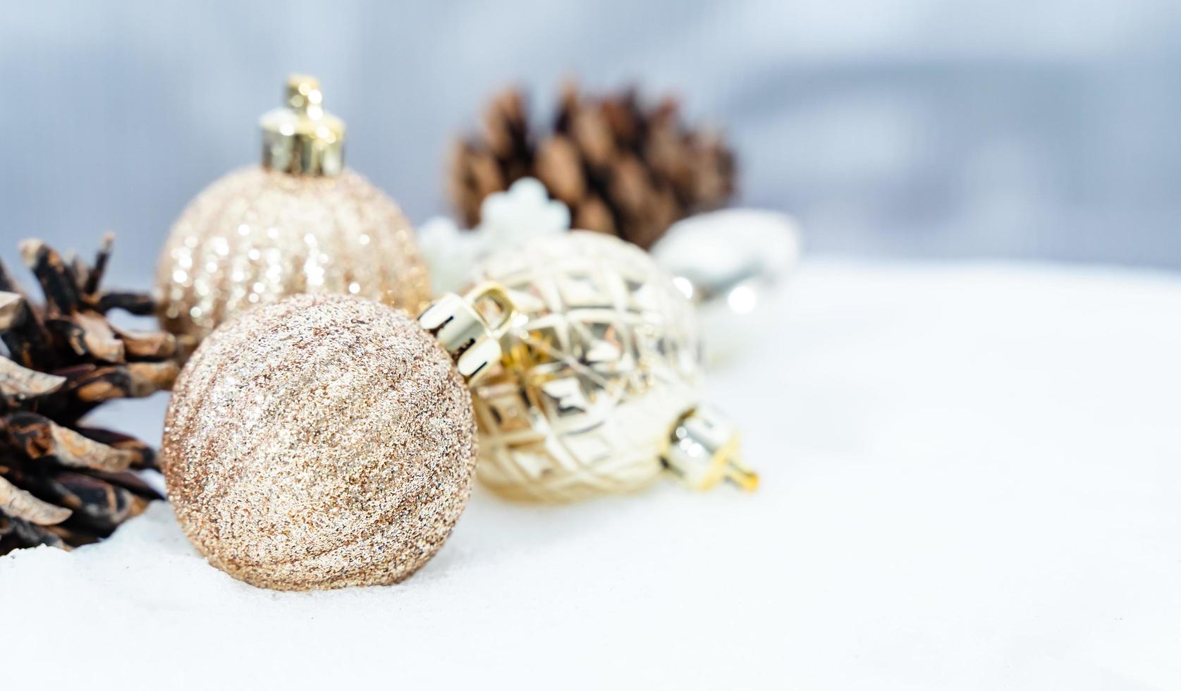 Kerstmis van winter - Kerstmis ballen met lint Aan sneeuw, winter vakantie concept. Kerstmis rood ballen, gouden ballen, pijnboom en sneeuwvlokken decoraties in sneeuw achtergrond foto