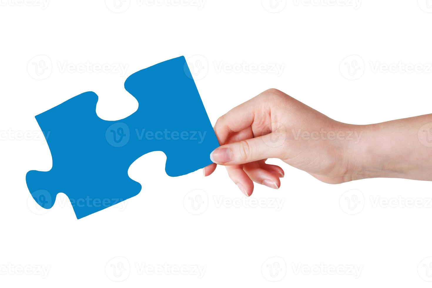 vrouw hand- met blauw puzzel stuk foto
