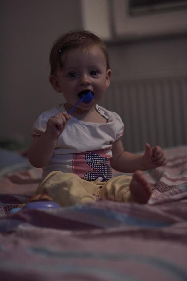 schattig weinig een jaar oud baby en maken eerste stappen in bed foto