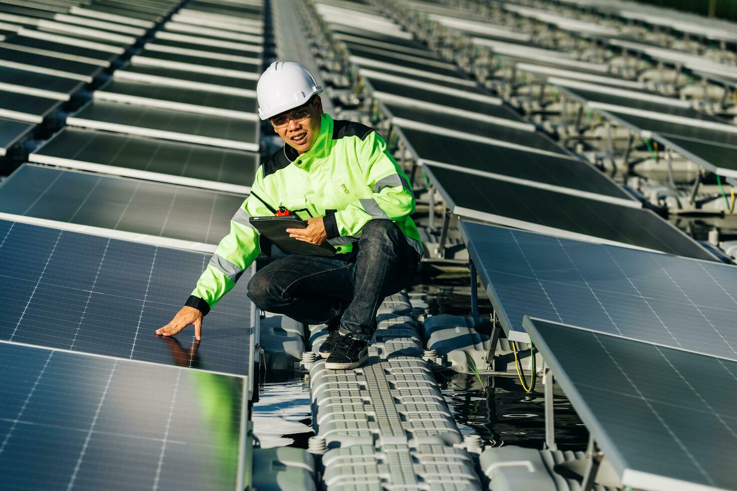 de portret van een jong ingenieur cheques fotovoltaïsche zonne- panelen. concept. hernieuwbaar energie technologie elektriciteit onderhoud, groen stroom. foto