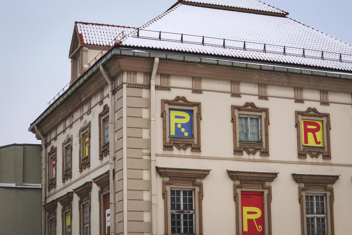 vilnius, Litouwen - december 2021 radvilai paleis facade in winter met verschillend r brieven in ramen en sneeuw Aan de dak foto