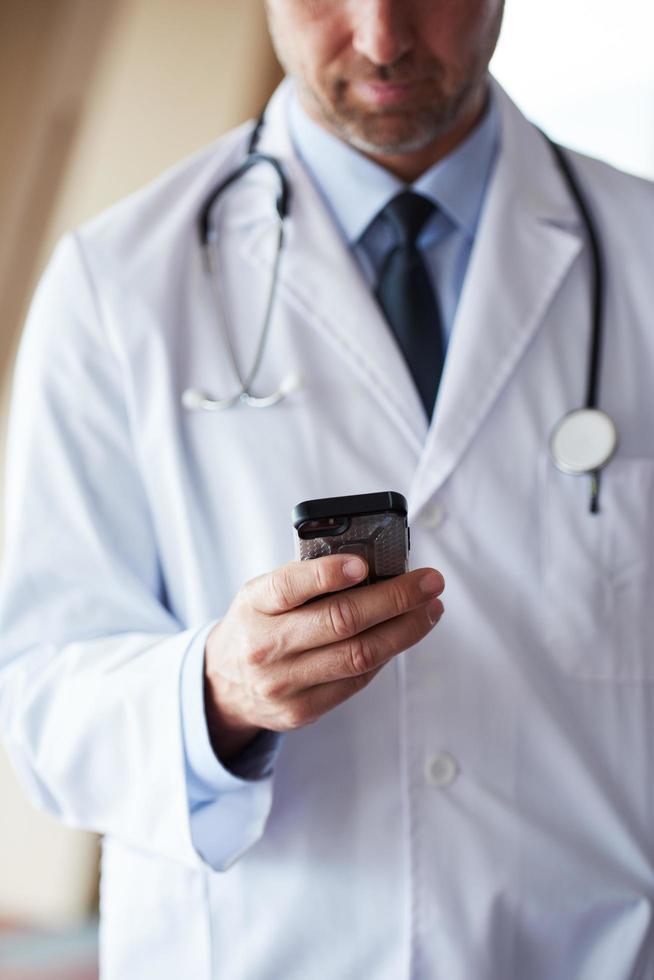 dokter sprekend Aan mobiele telefoon foto